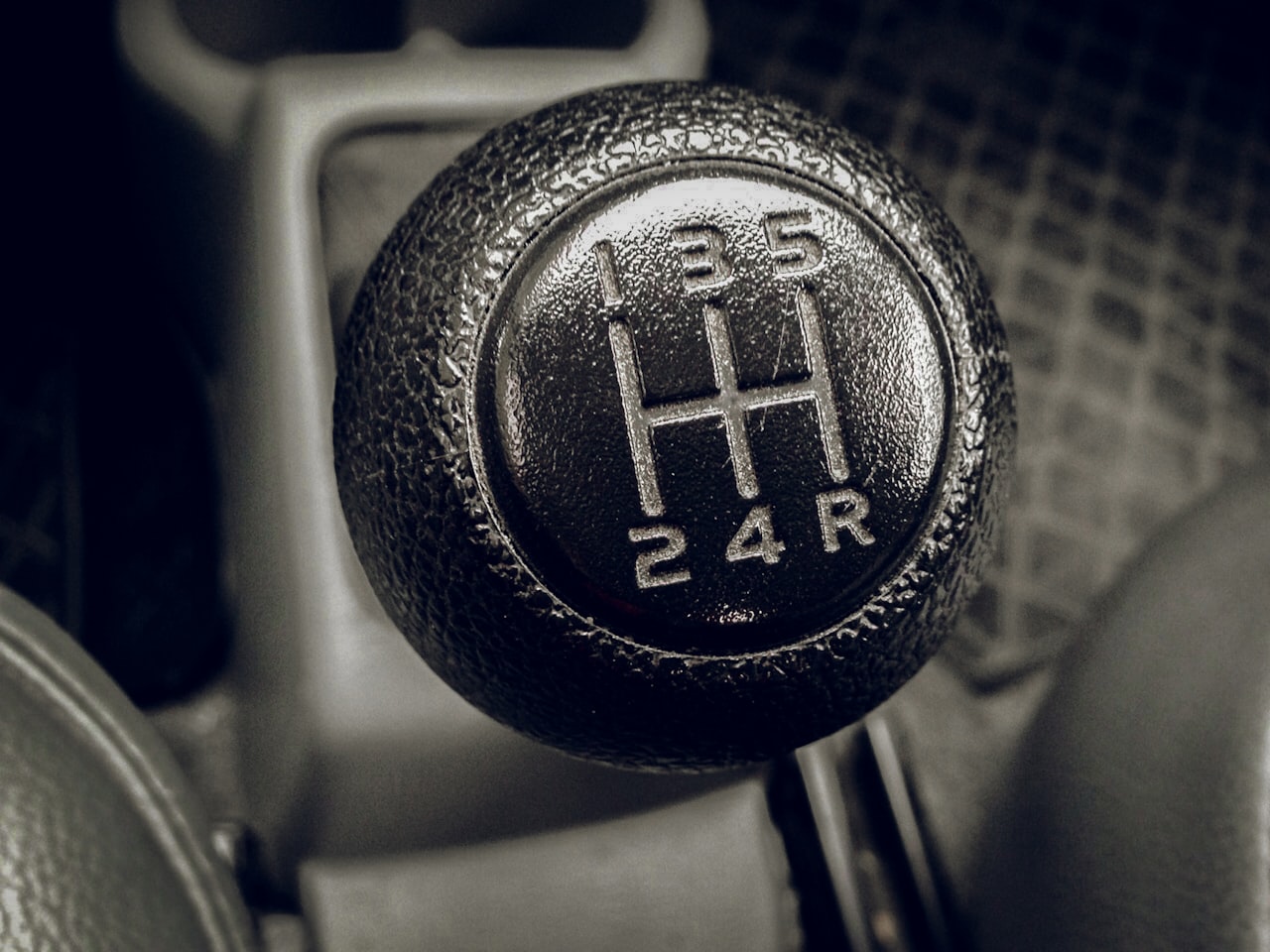 Close-up of a manual gearbox gear stick with the H-pattern