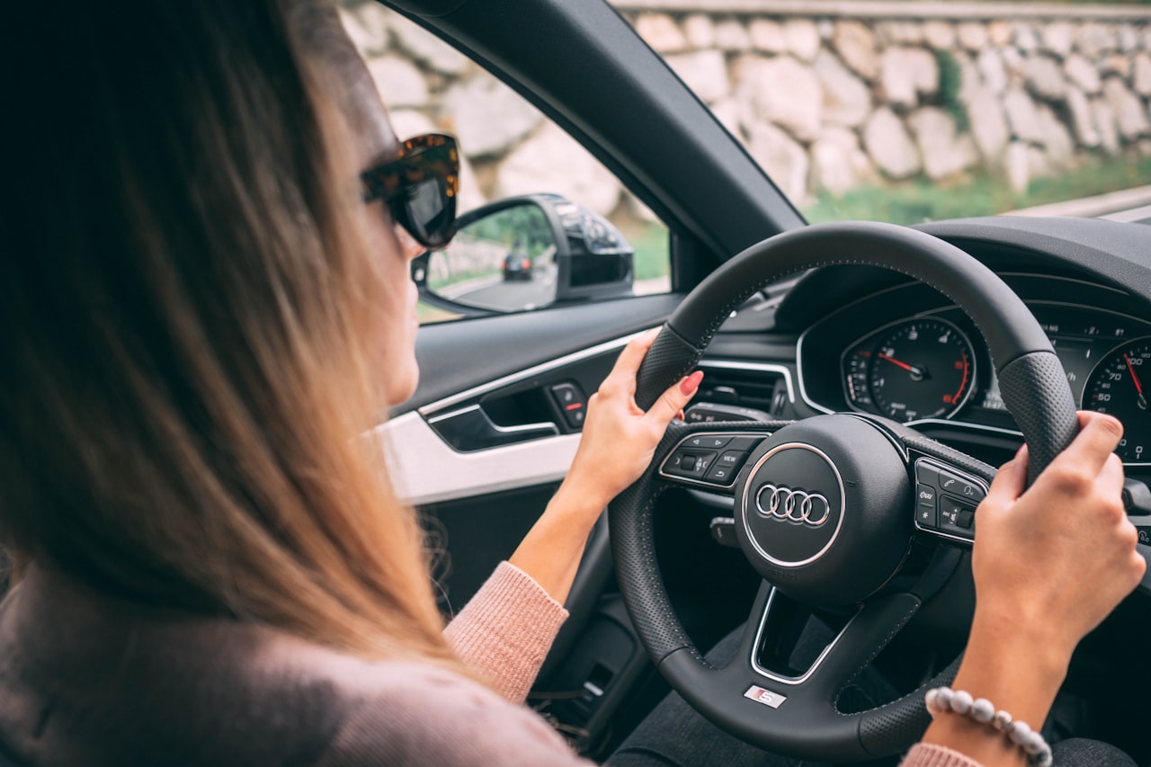 A calm driver with both hands on the steering wheel