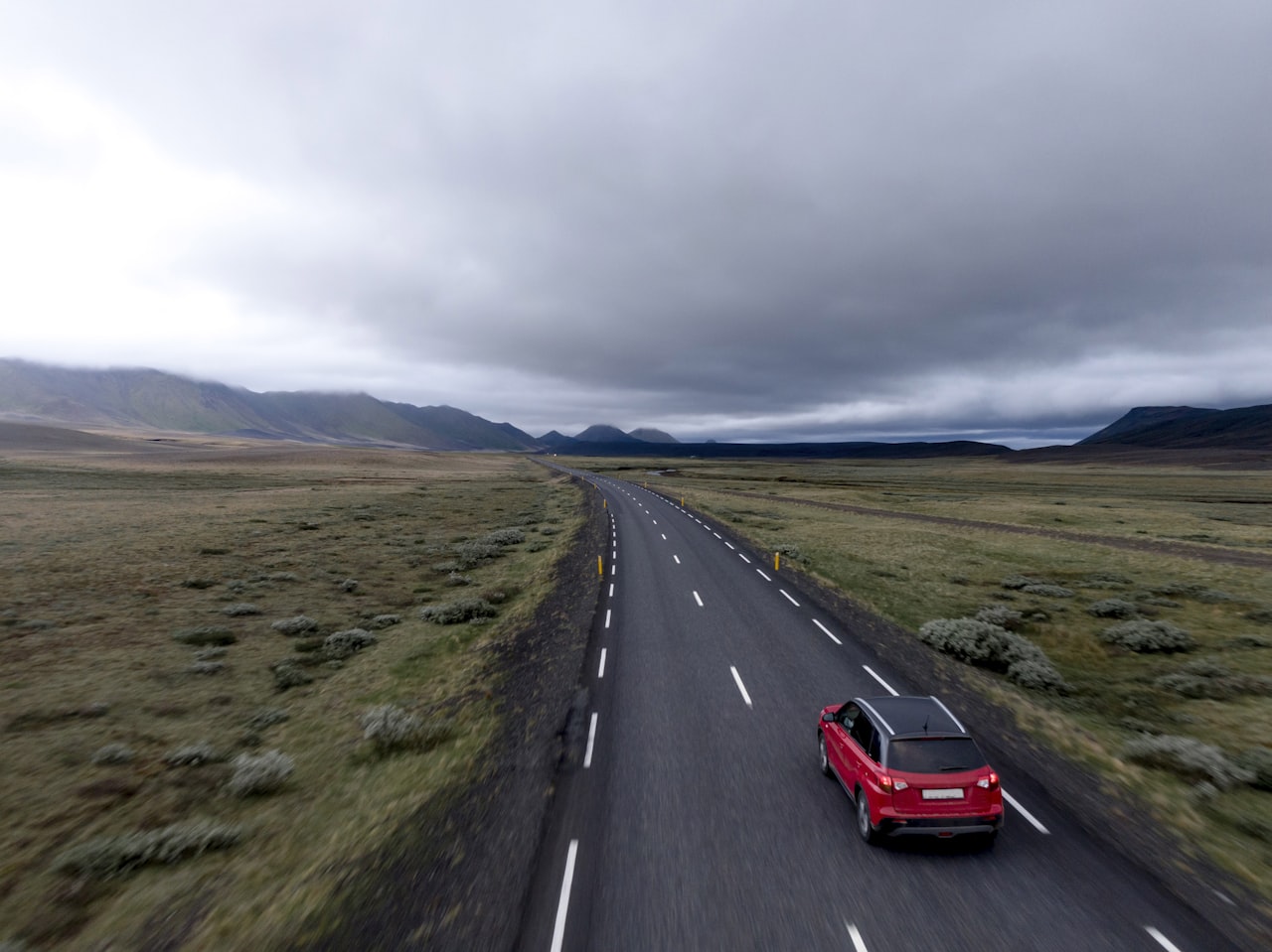 A car driving on an open country road